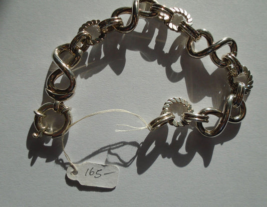 Silver bracelet with figure of eight as part of its chain image 0